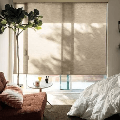 Elegant living room with custom shades and drapery installed